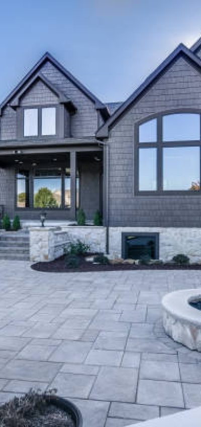 Stone and concrete back patio area with lots of entertaining options